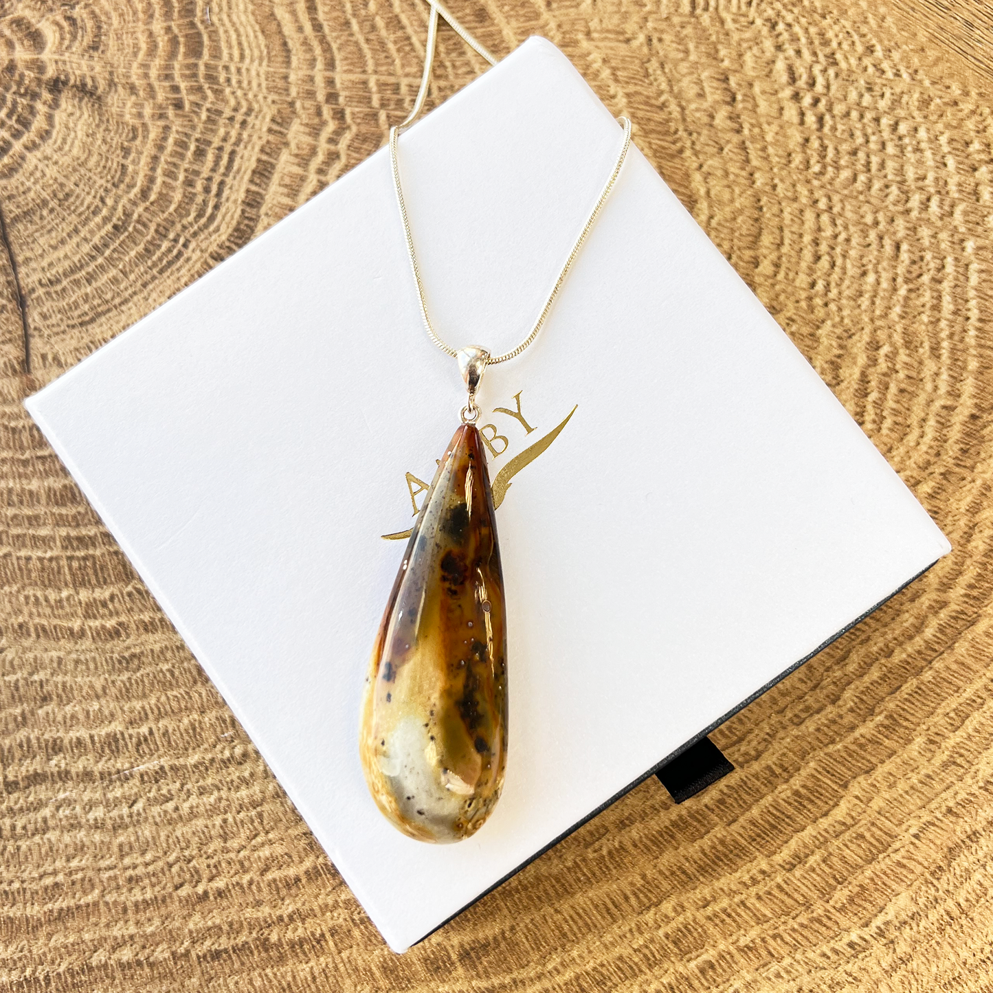 Quail amber pendant "Black-white"